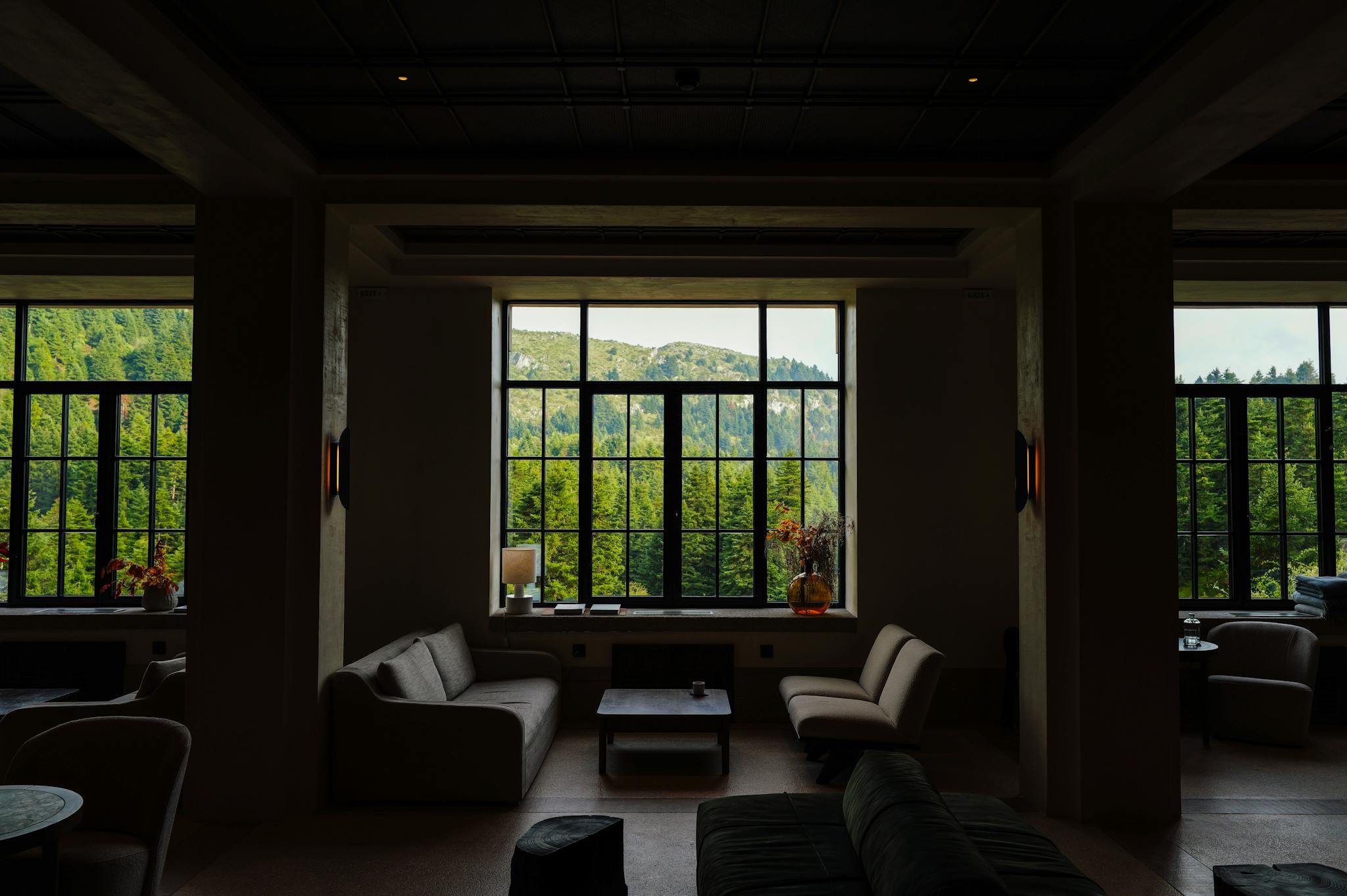 Elegant lounge interior with a breathtaking mountain view through large windows.